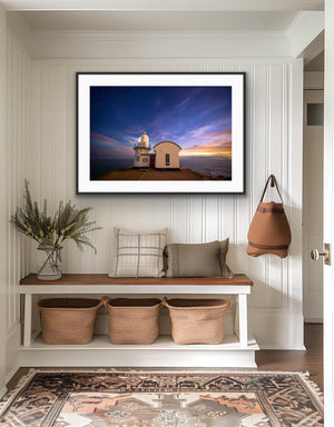 Last Light framed above a bench in a bright coastal-inspired entryway
