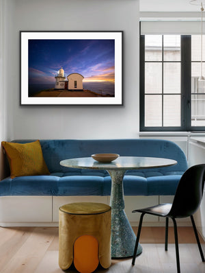 Last Light framed above blue banquette seating in a contemporary kitchen nook