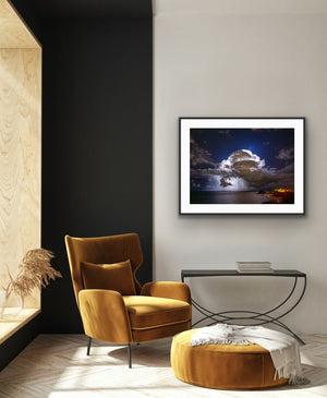 Storm over Nobby's framed in a modern lounge with warm ochre seating