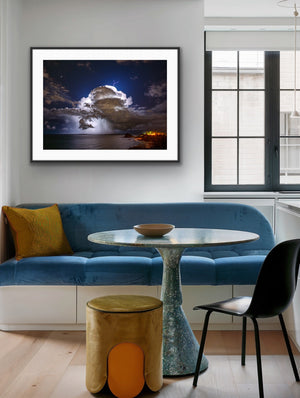 Storm over Nobby's framed above blue banquette seating in a contemporary dining nook