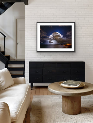 Storm over Nobby's framed on a white brick wall in a modern living room