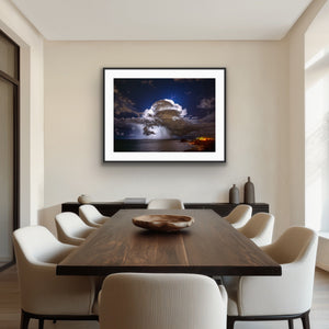 Storm over Nobby's framed above a timber dining table in a refined contemporary interior