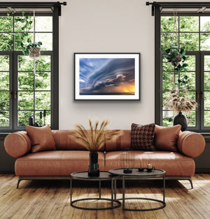 Sunset Storm framed above a leather sofa